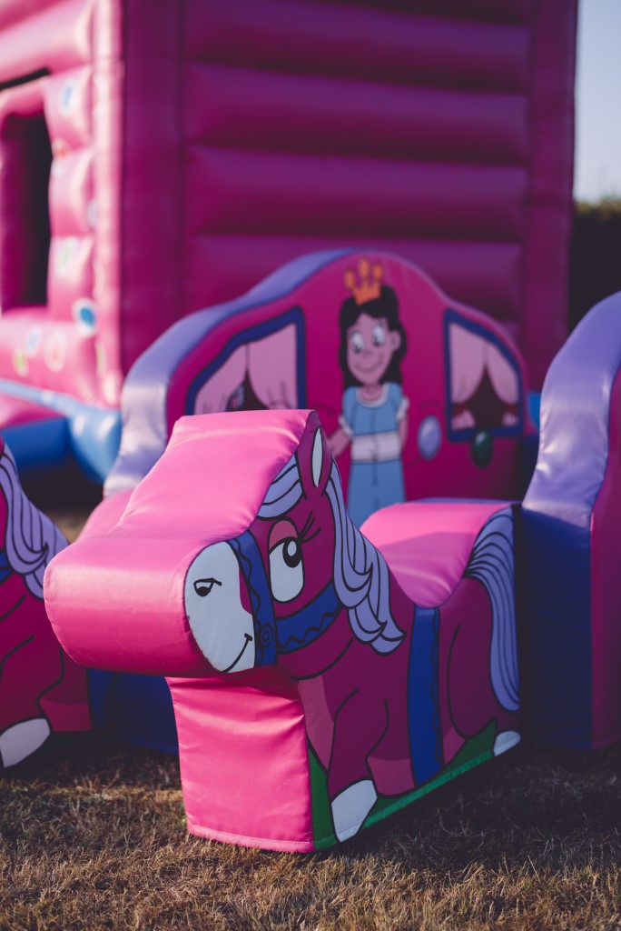 pink bouncy castle and inflatables to hire