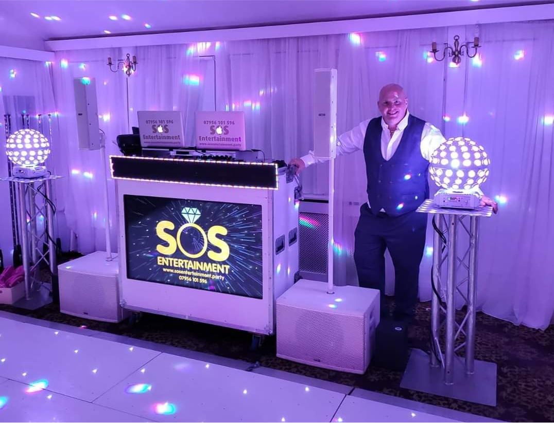 IMage shows SOS Entertainment DJ Sean with digital DJ booth and LED dance floor